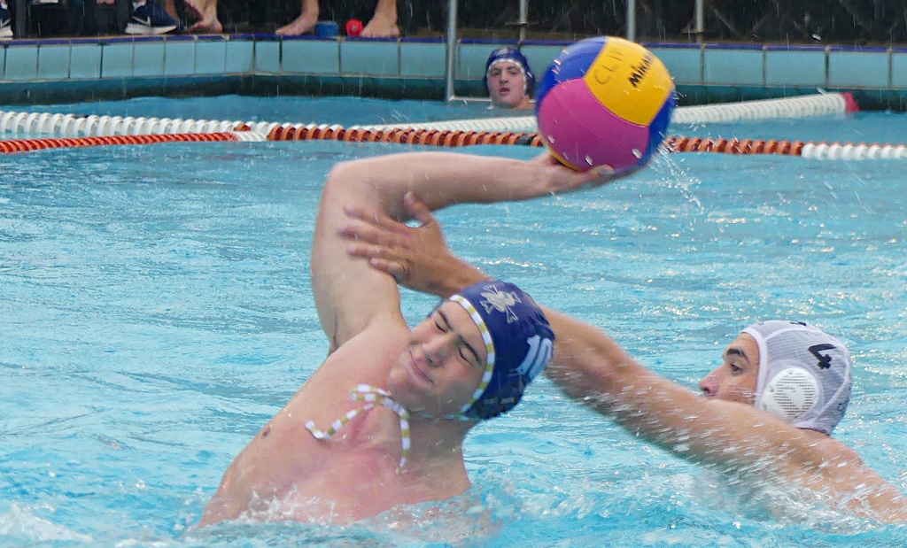 Northwood's Tristan Parkinson gets a shot off under heavy pressure from Hilton's Lincoln Burger. (Photo: Brad Morgan).